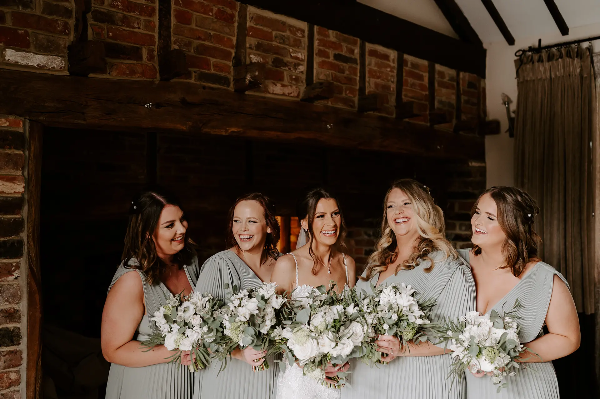 Bride and bridesmaids getting ready in Rivervale Barn's honeymoon suite, the Cornstore Cottage