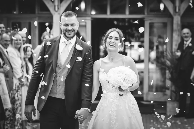 Bride and groom's confetti throw wedding photo at Rivervale Barn