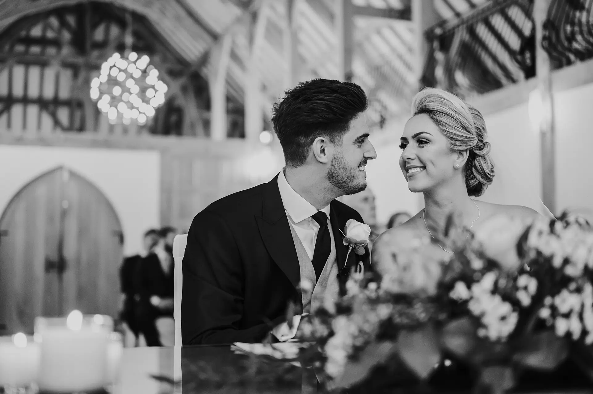 Couple smiling at each other during their ceremony in The Ceremony Barn at Rivervale Barn