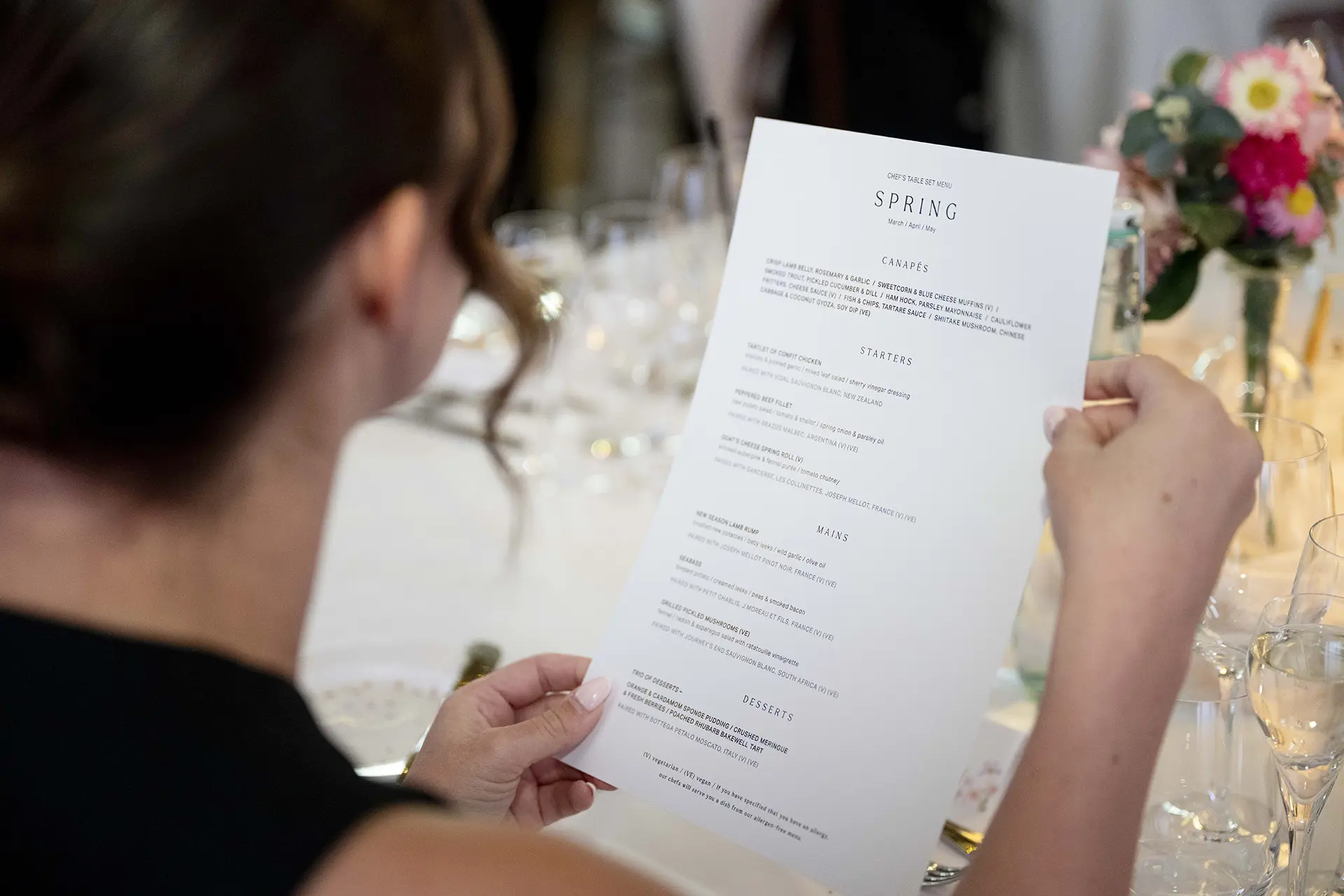 Guest looking at the Spring Chef's Table event menu