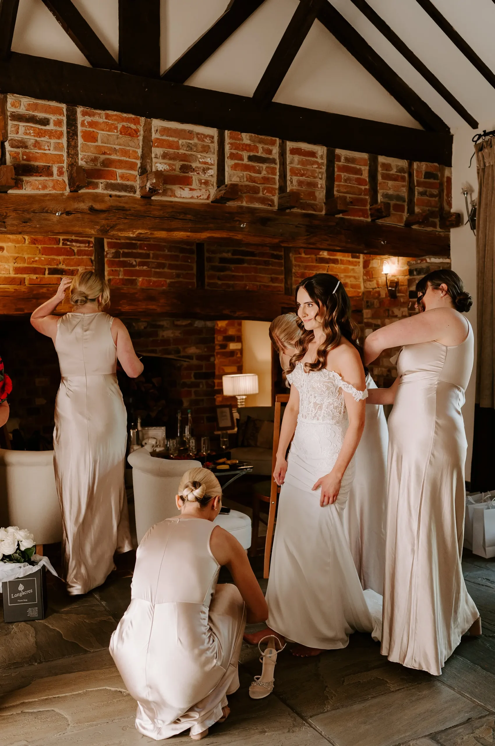 Bride and bridesmaids getting ready in the Cornstore Cottage honeymoon suite at Rivervale Barn