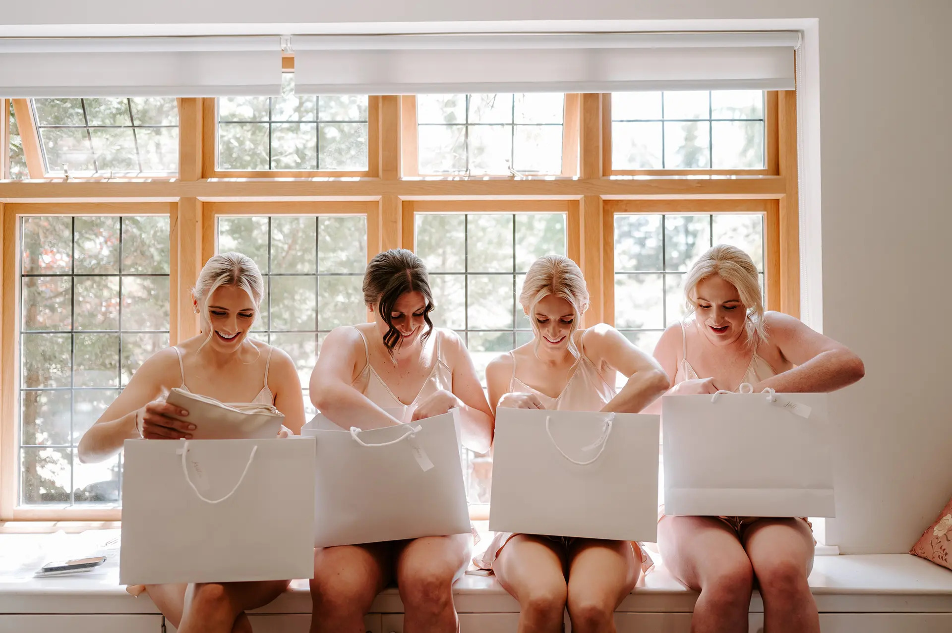 Bridesmaids opening presents in Rivervale Barn’s Pamper Room