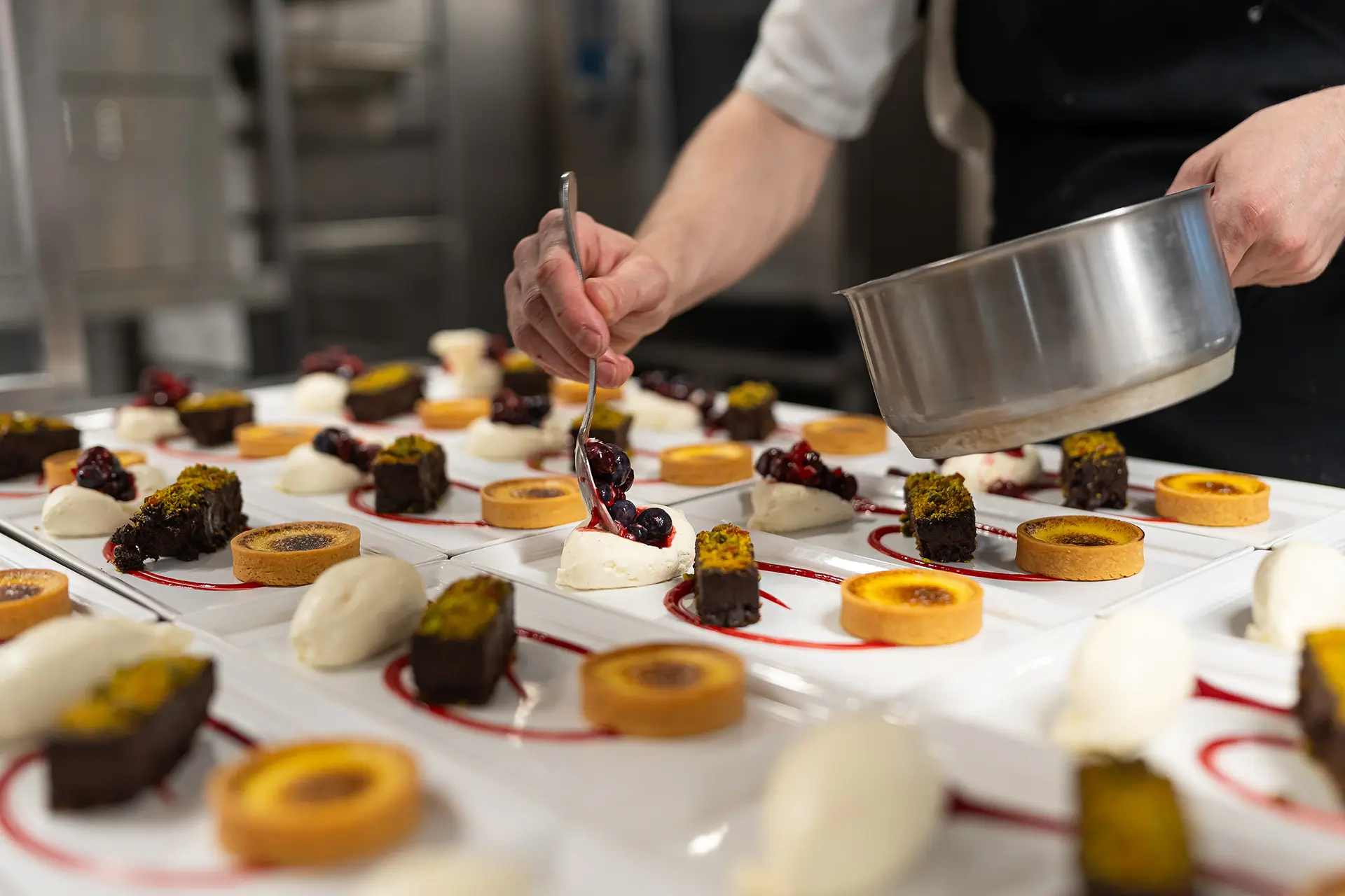 Chef preparing dessert dishes from the seasonal chef's table menu at Rivervale Barn
