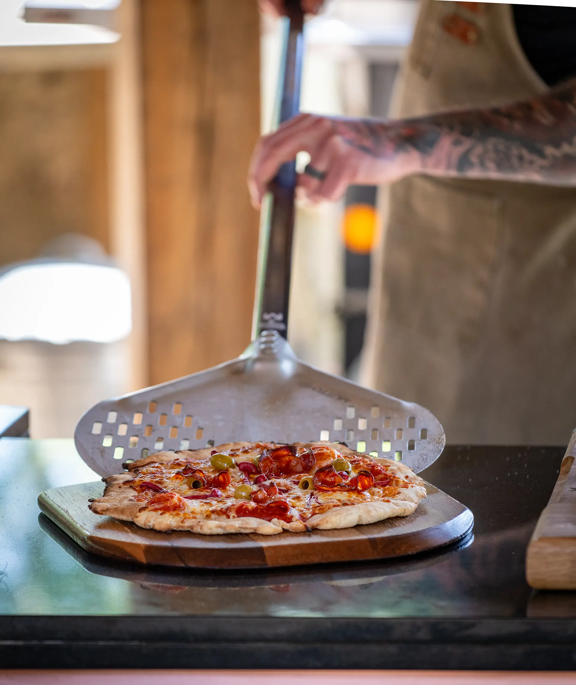 Wood fired pizza being served in the outdoor kitchen at Rivervale Barn