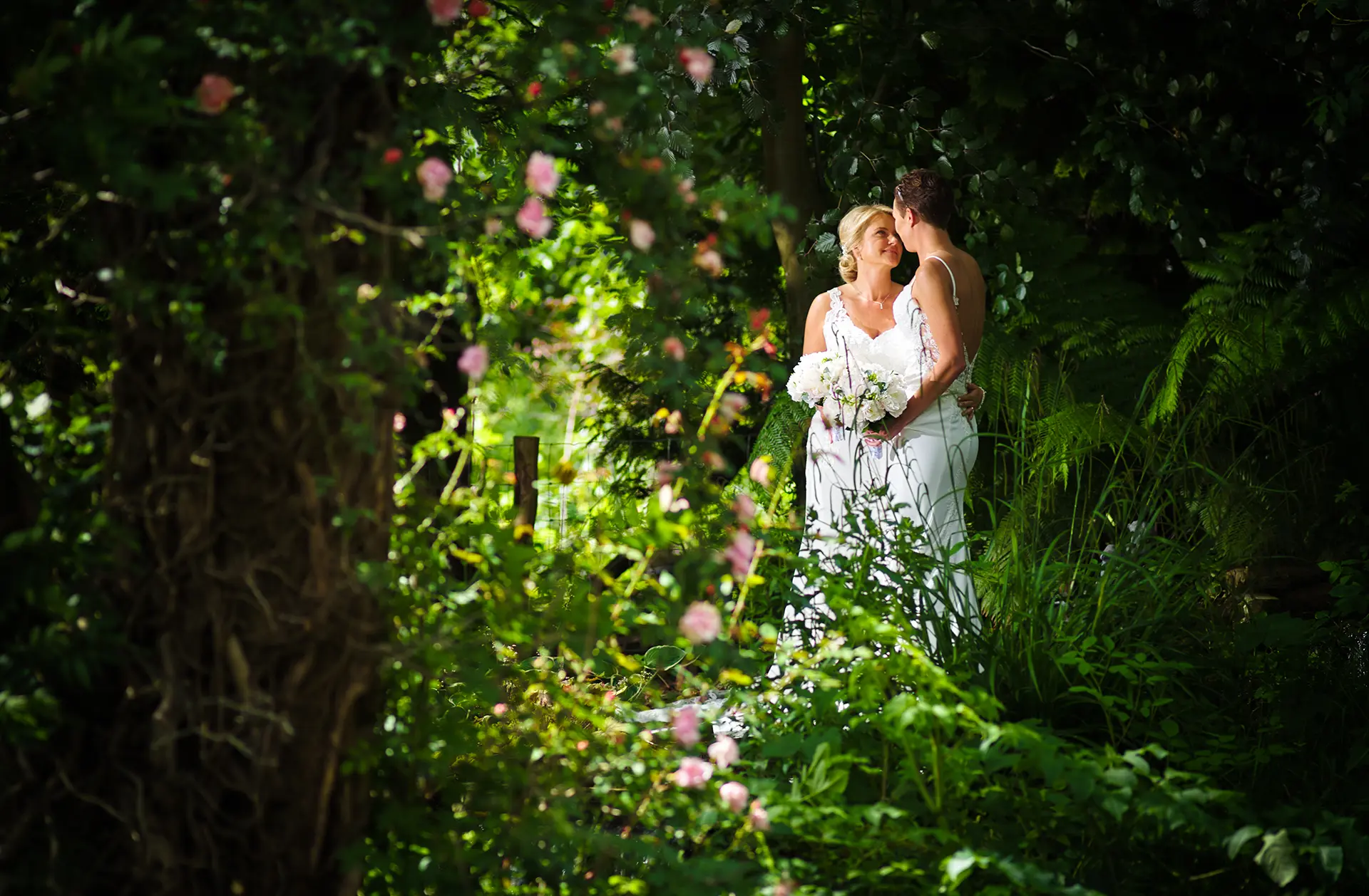 Same sex couple having their wedding day photos taken in Rivervale Barn's gardens