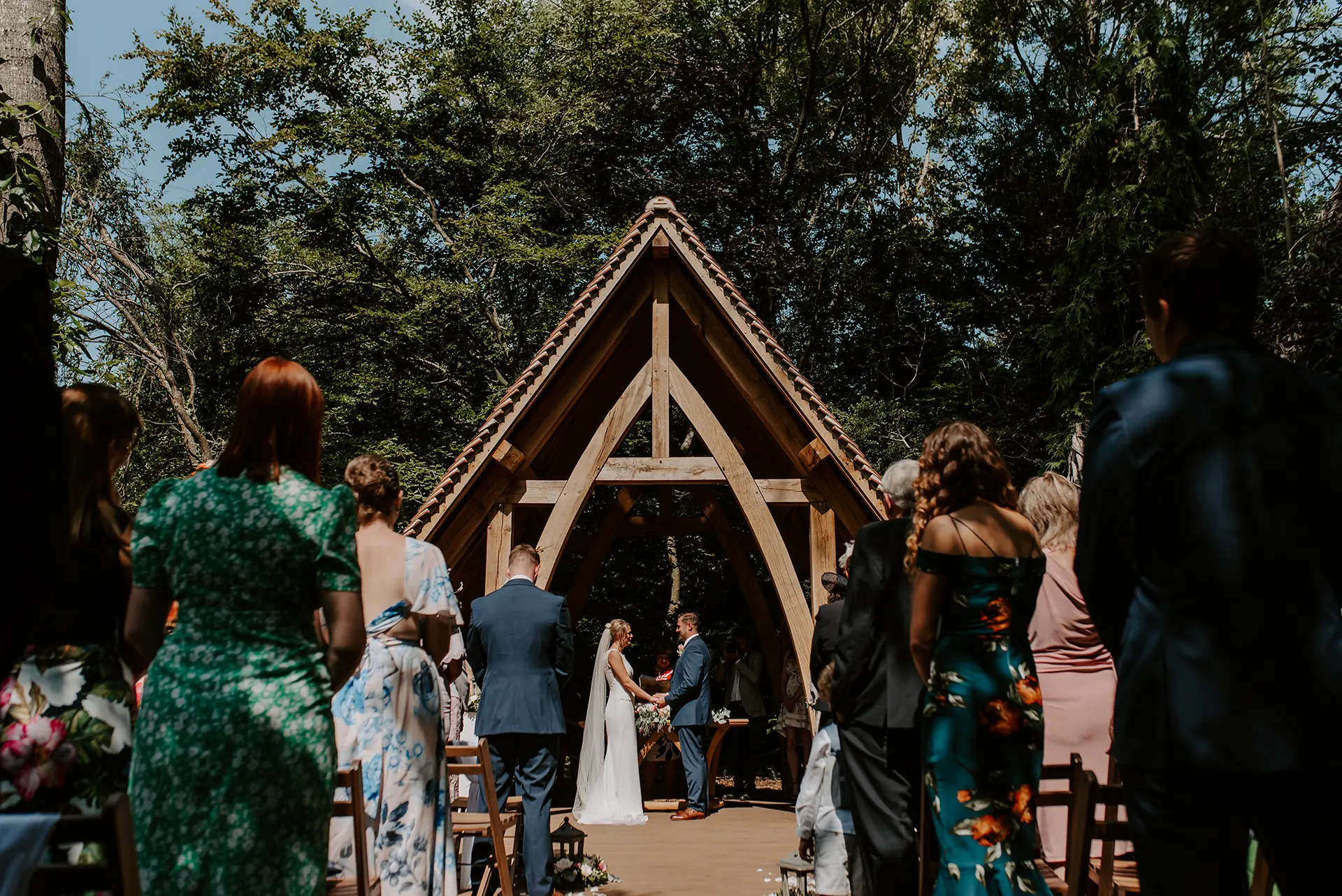 Couple getting married in the outdoor ceremony space at Rivervale Barn, The Spinney