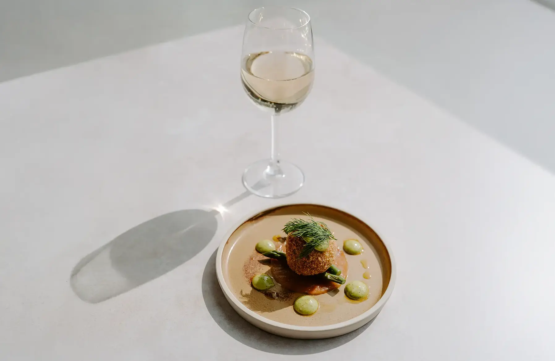 Salt cod croquette paired with a glass of wine from Rivervale Barn's spring/summer menu