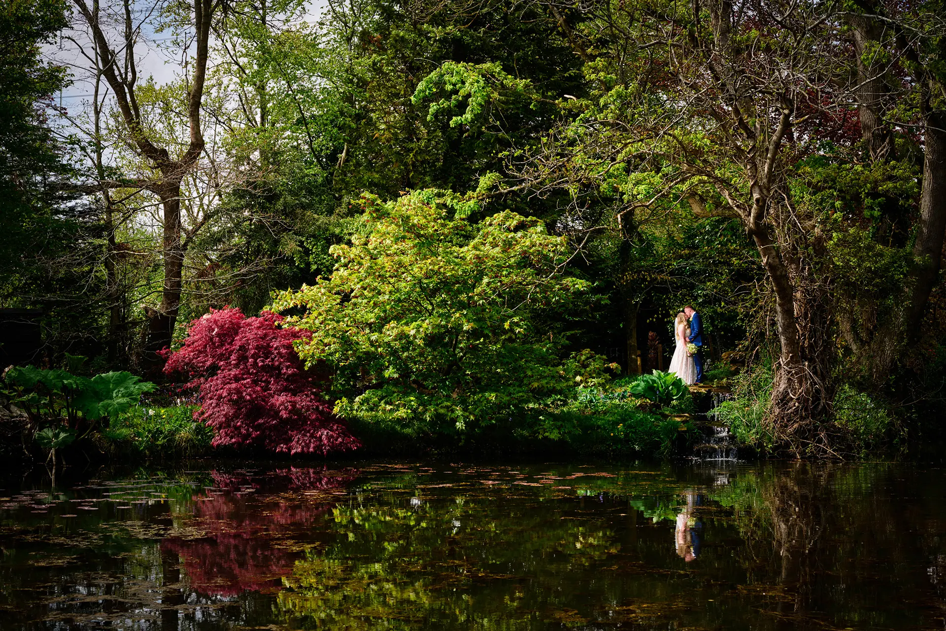 Bride and groom in Rivervale Barn's gardens