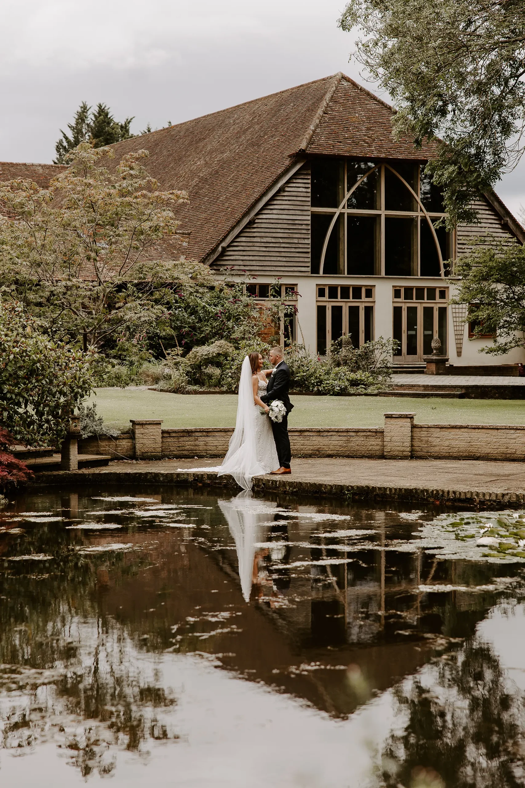 Couple getting their wedding day photos at Rivervale Barn's gardens