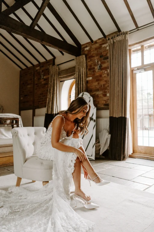 Bride getting ready for her wedding in the Cornstore Cottage at Rivervale Barn