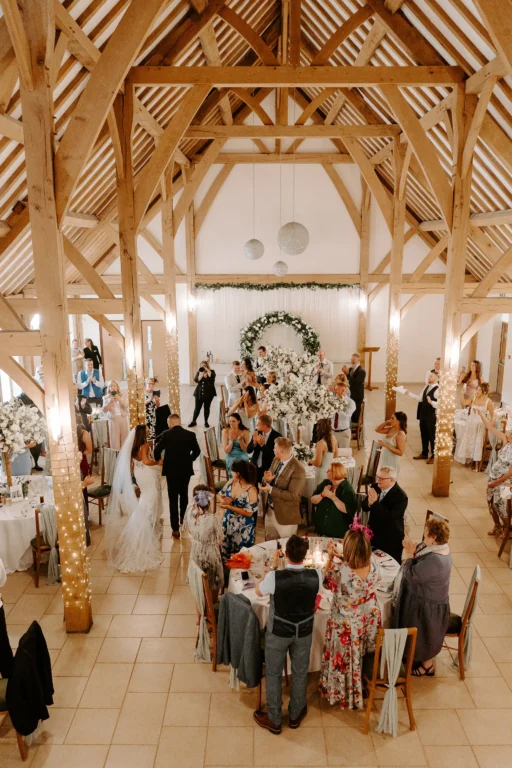 Guests about to sit down for the wedding breakfast in the Dining Barn at Rivervale Barn