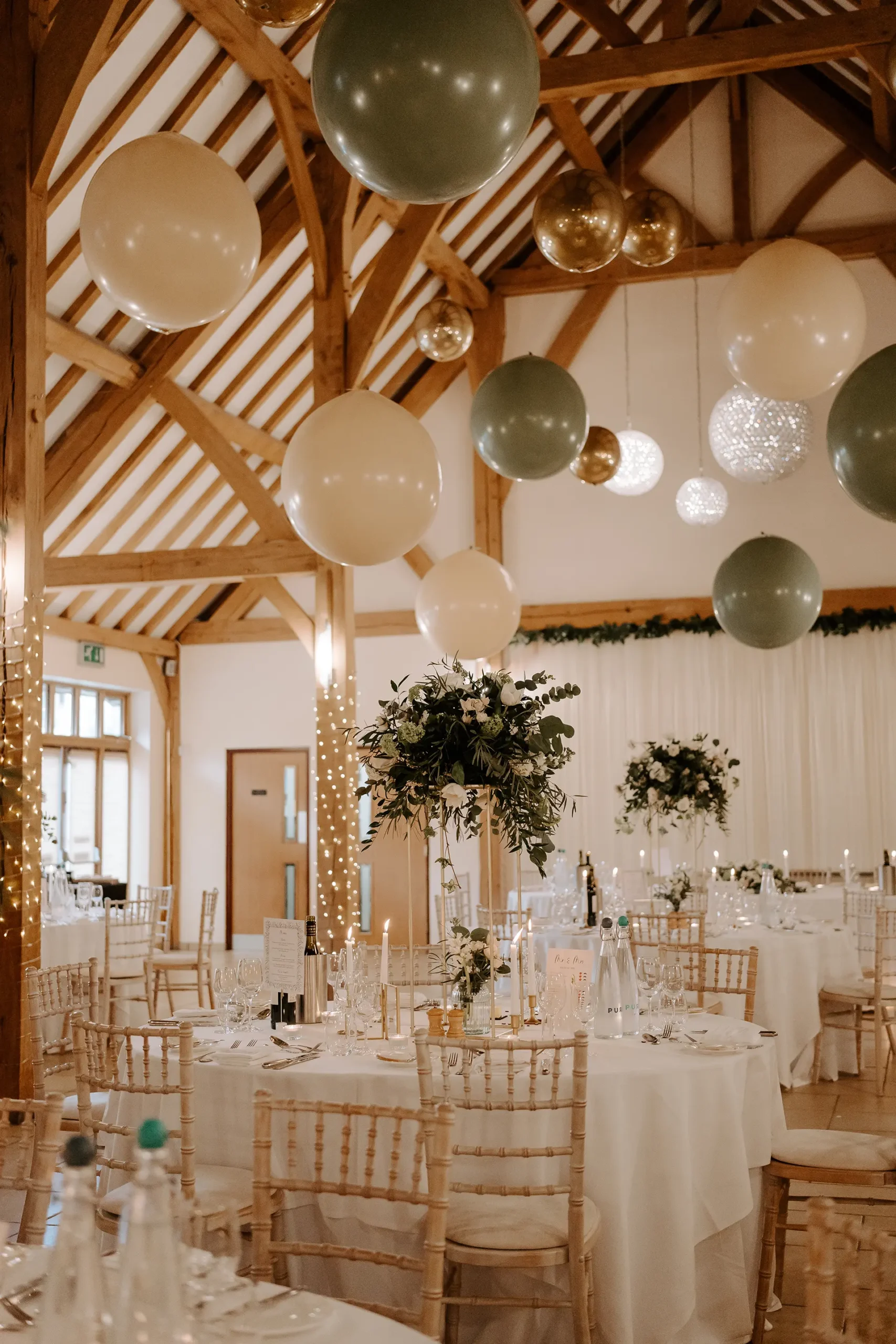 The Dining Barn dressed for a wedding reception with balloons and candles at Rivervale Barn