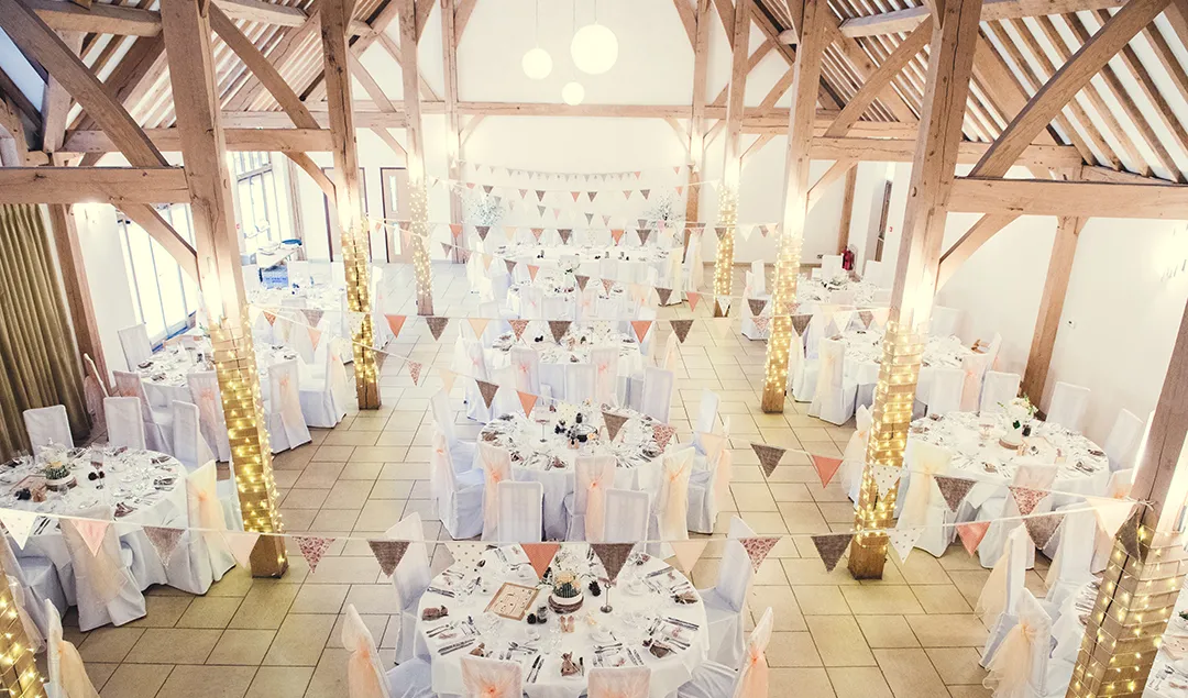 the dining barn in this beautiful Hampshire wedding venue all set up for an autumnal wedding