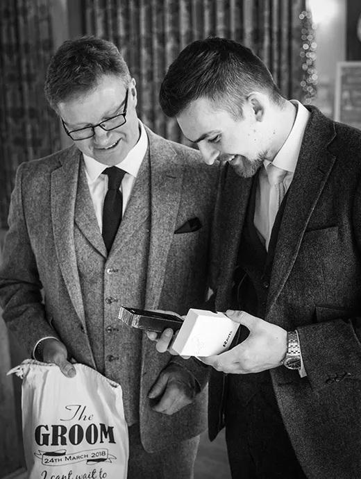 the groom received a gift from his partner before the wedding ceremony at Rivervale Barn