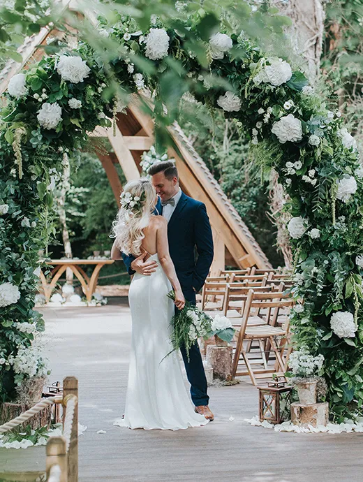 The gorgeous flower arch compliments The Spinney perfectly bringing the outdoor ceremony space to life