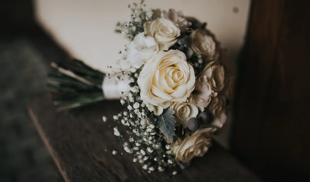 A simple white rose arrangement made the perfect addition to this Christmas themed wedding in Hampshire