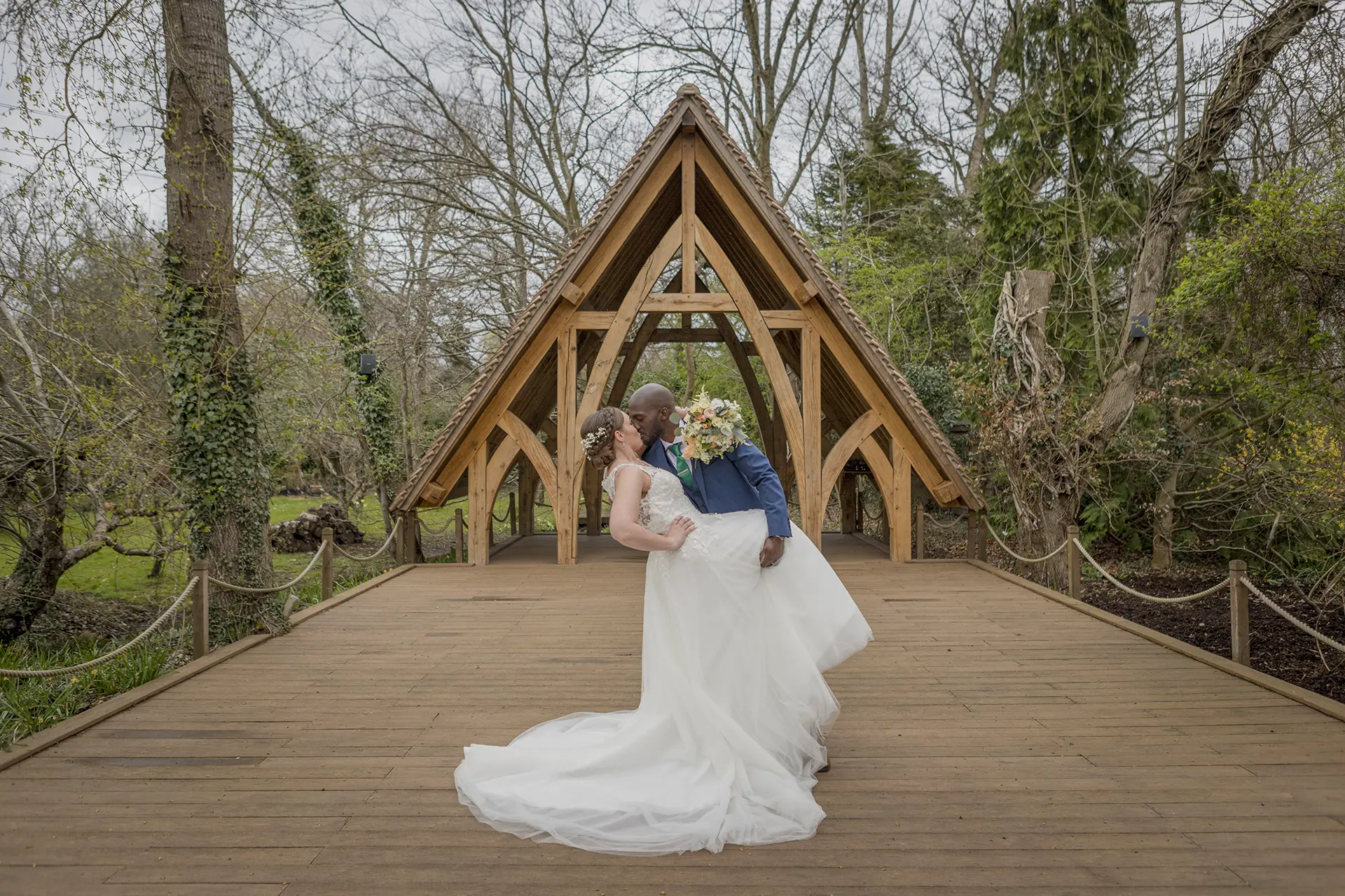Couple having their wedding photos taken in the Spinney at Rivervale Barn
