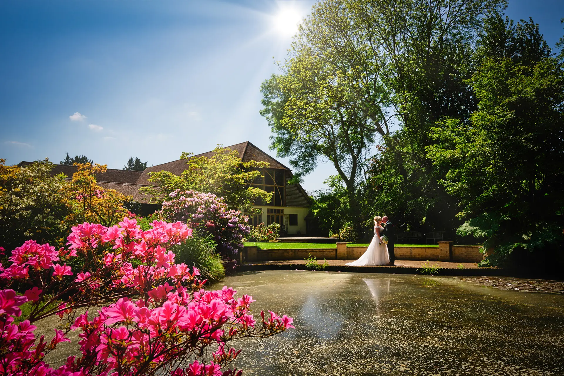 Couple having their photos taken for their summer wedding in Rivervale Barn's gardens