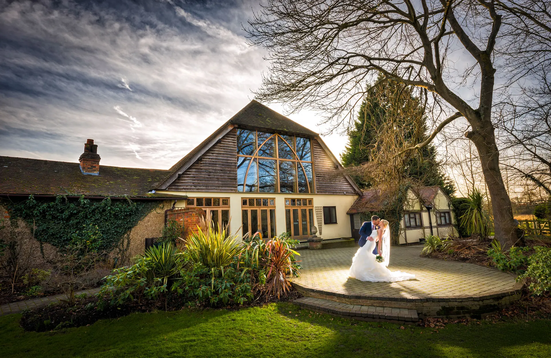 Couple having their wedding pictures taken outside Rivervale Barn