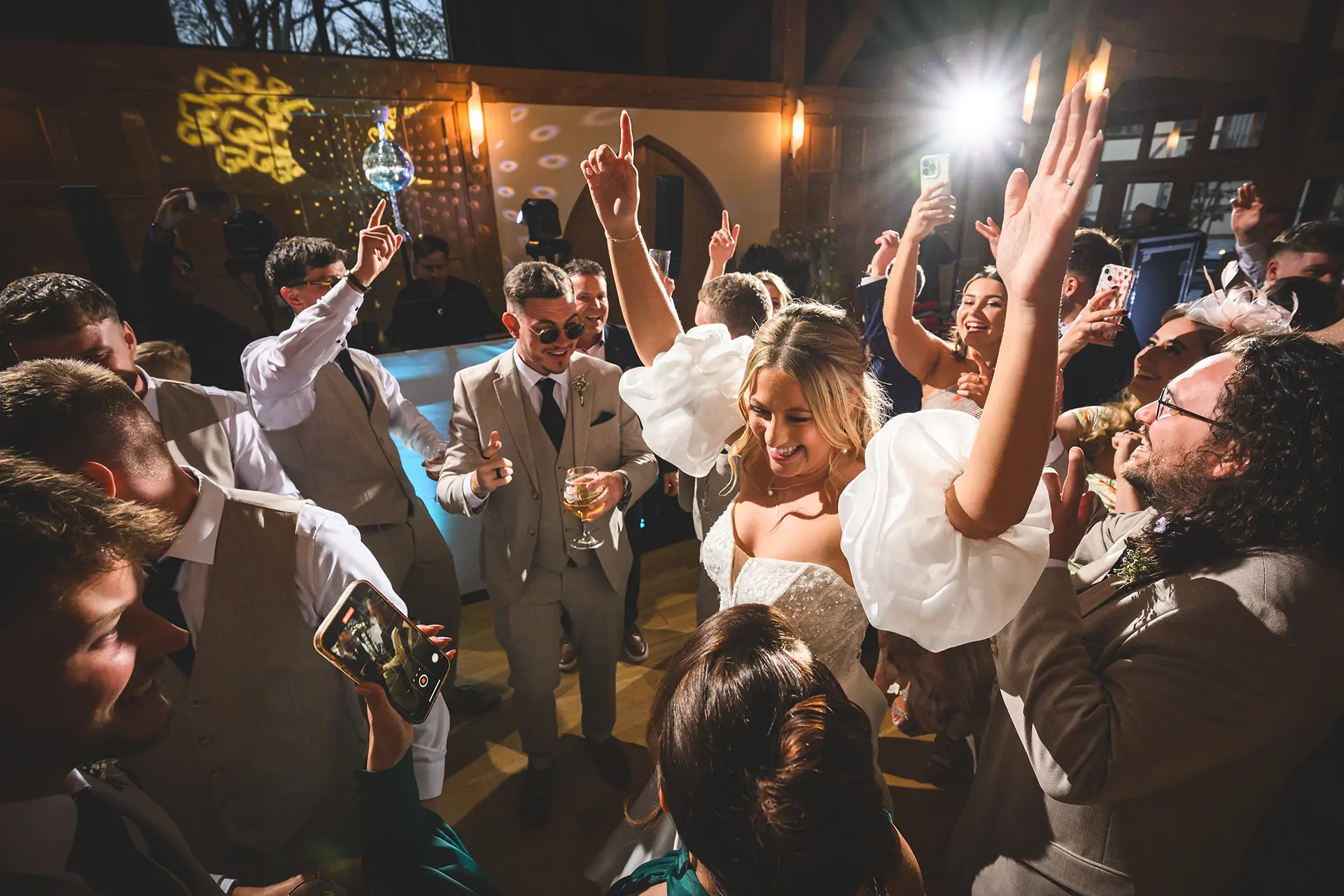 Wedding party dancing at an evening reception at Rivervale Barn