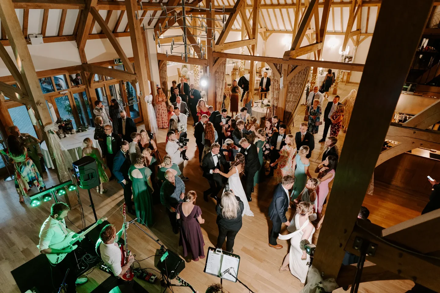 An evening wedding reception taking place on the dancefloor at Rivervale Barn