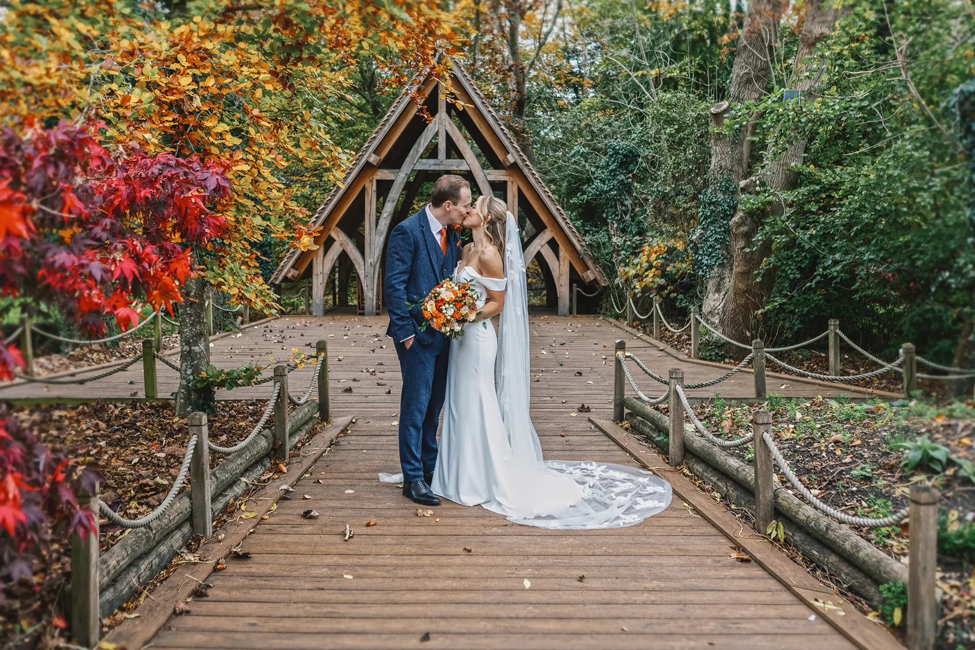 Couple kissing by the Spinney at Rivervale Barn in autumn