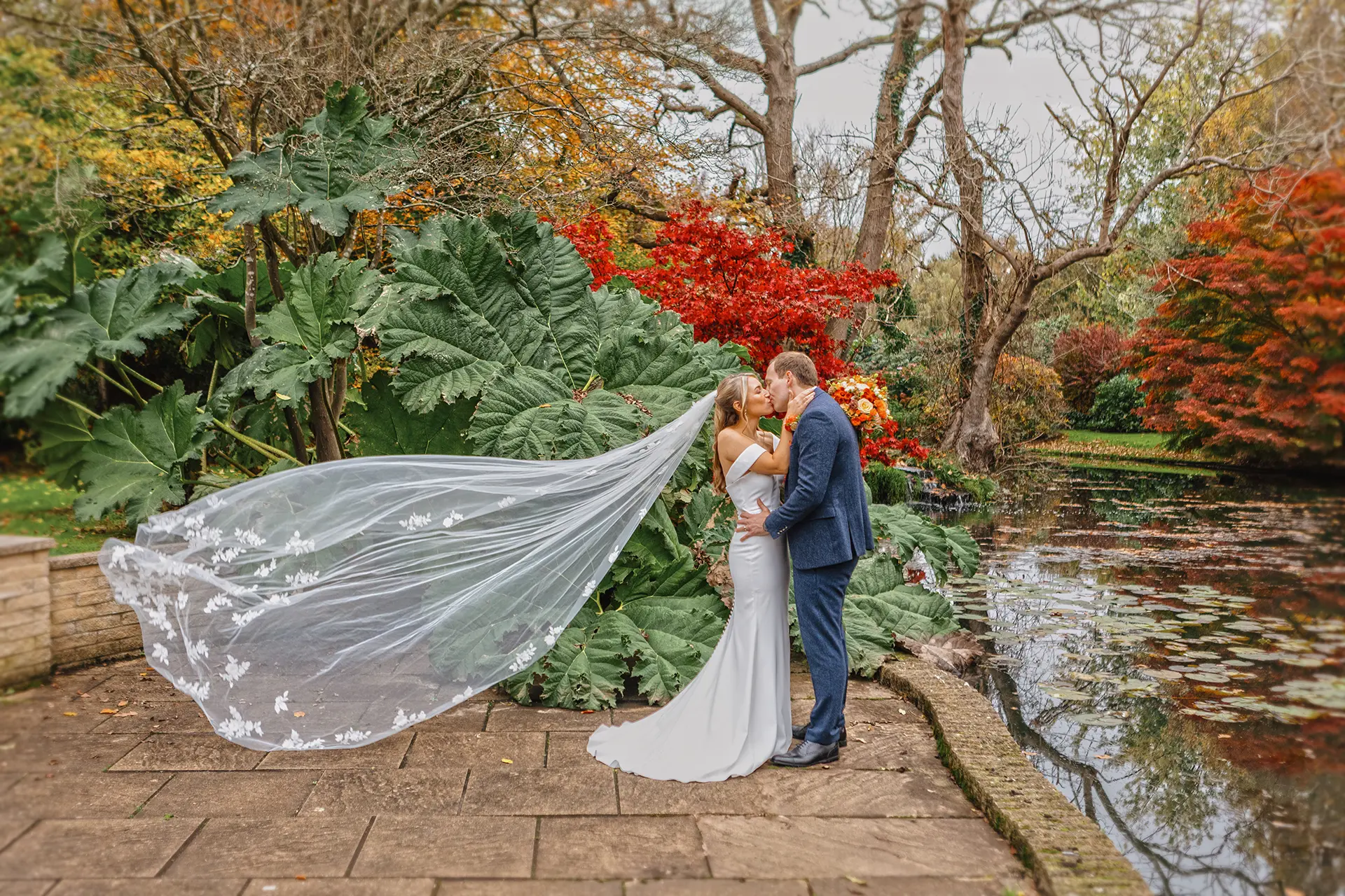 Couple having their wedding photos taken in Rivervale Barn's gardens in autumn