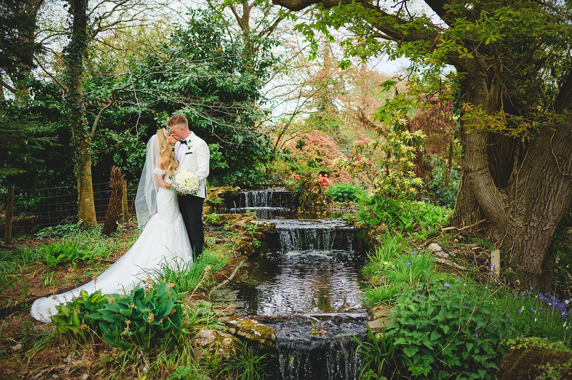 Couple having their wedding photos taken in Rivervale Barn's gardens