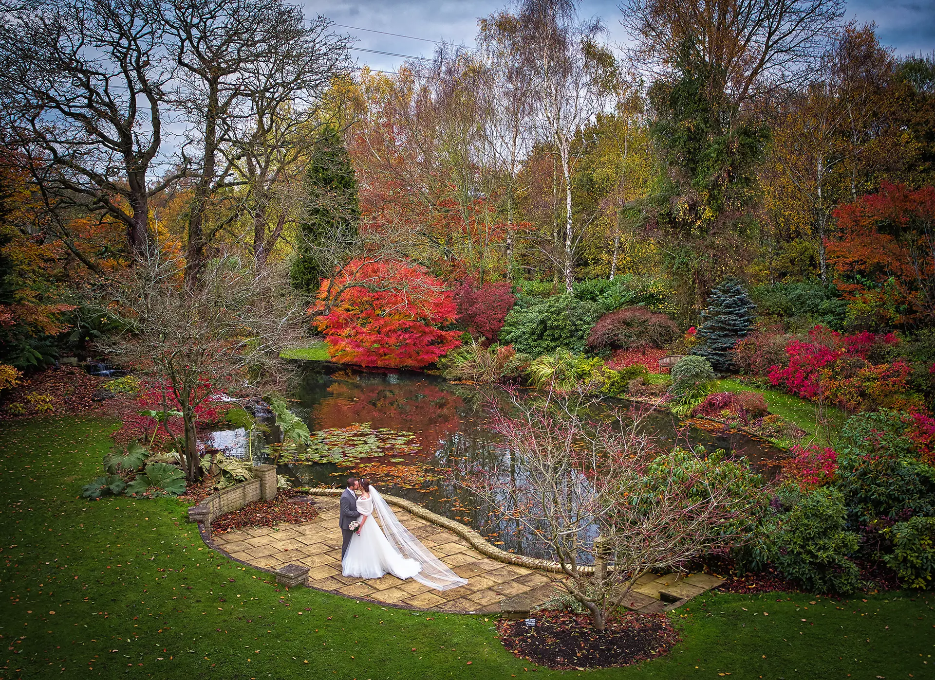 Couple having their wedding photos taken in Rivervale Barn's gardens in autumn