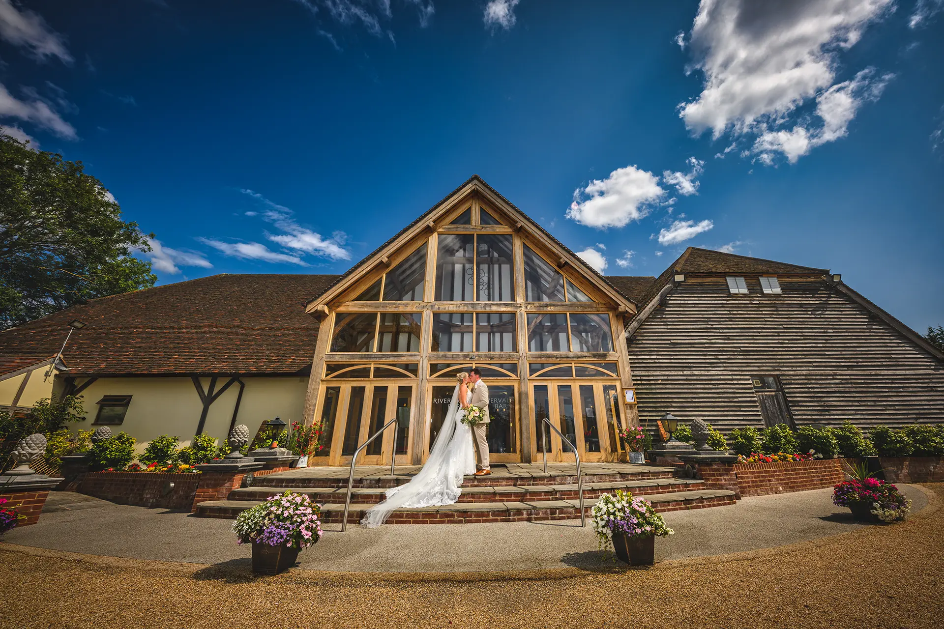 Bride and groom outside Rivervale Barn wedding venue