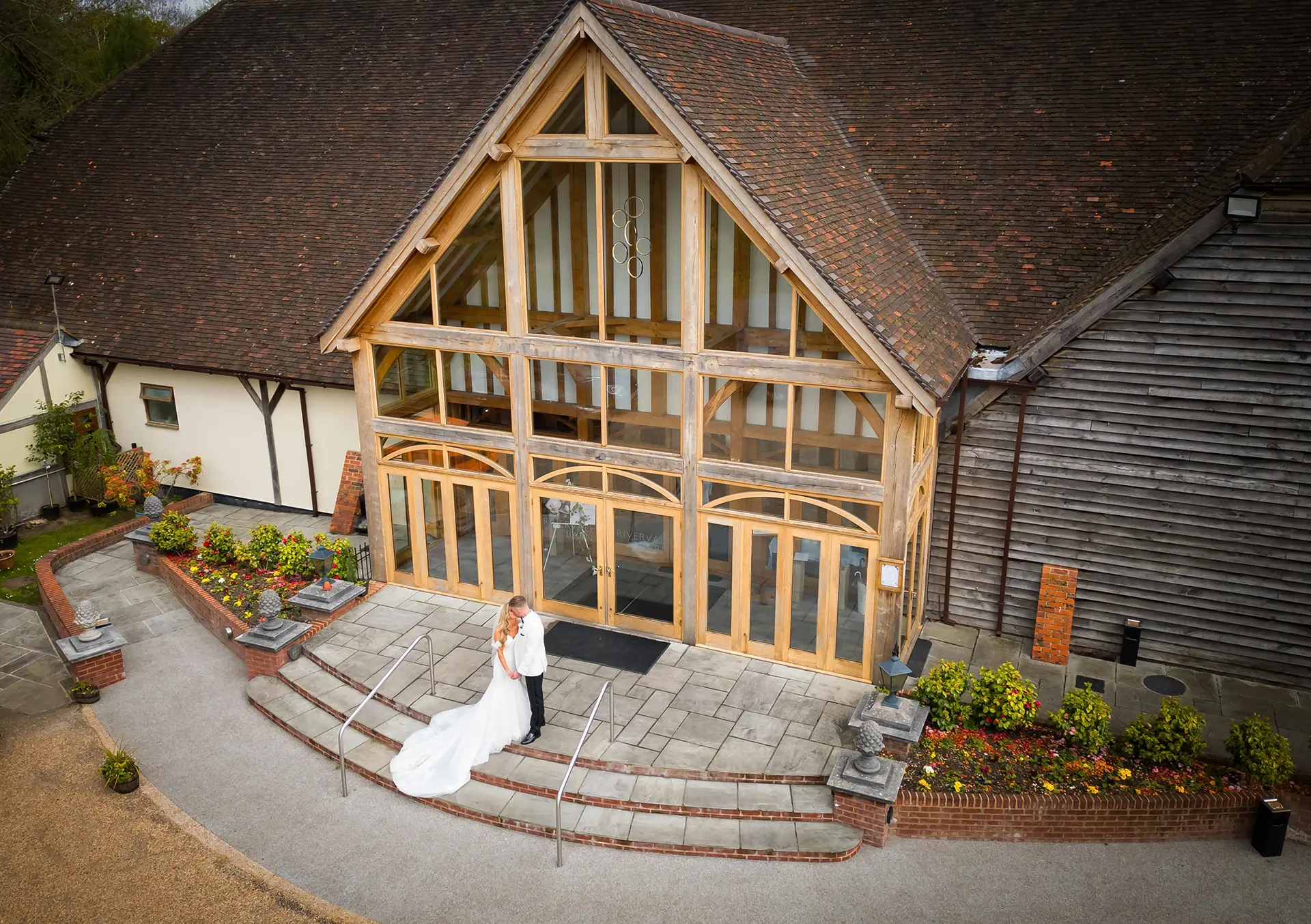 Couple having their weddings photos taken outside Rivervale Barn venue