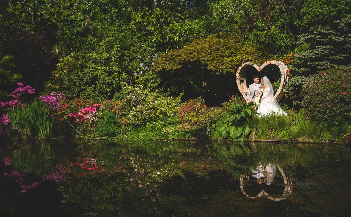Couple having their wedding photos taken in the gardens at Rivervale Barn