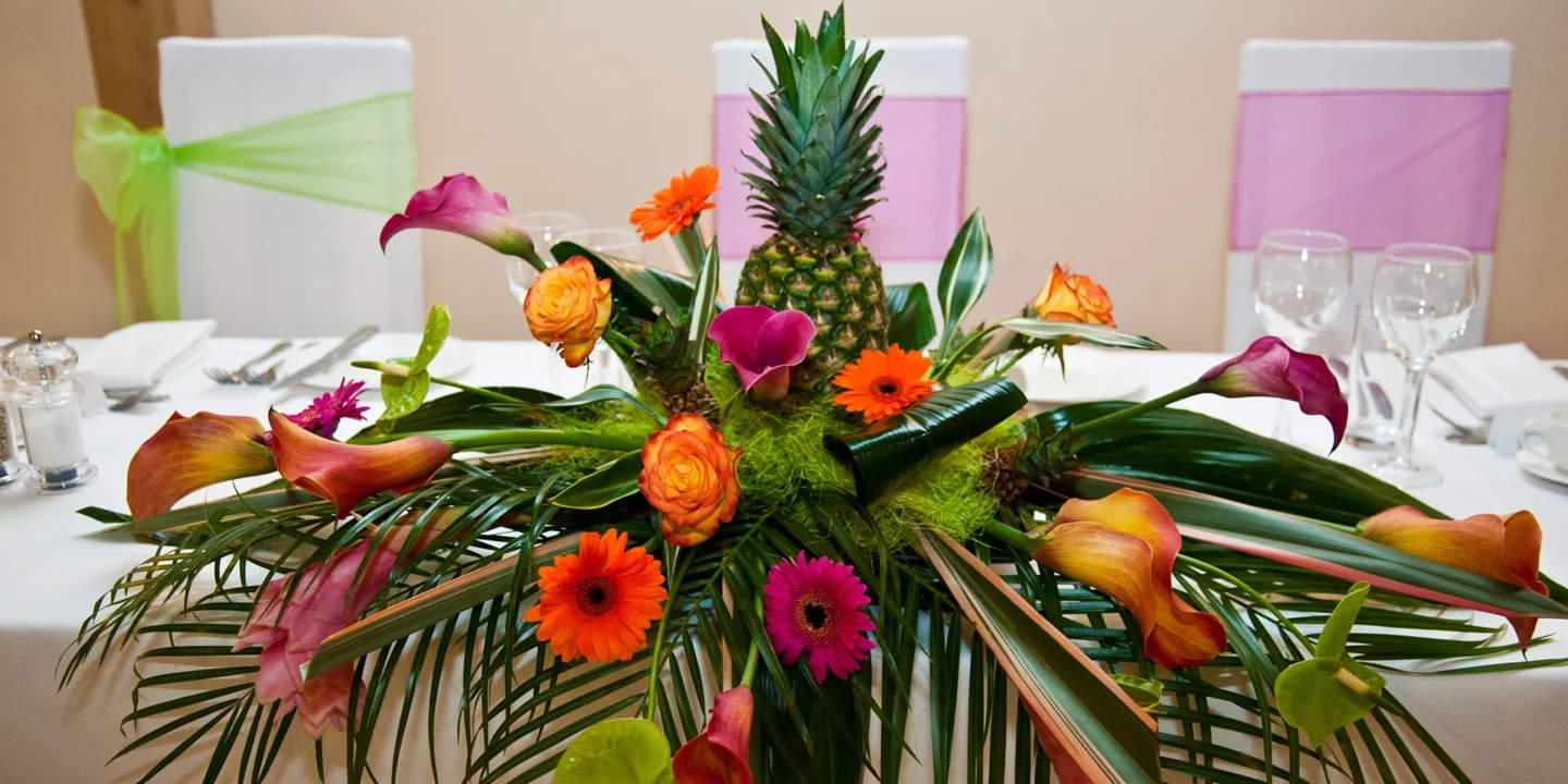Tropical themed floral arrangement at a wedding at Rivervale Barn