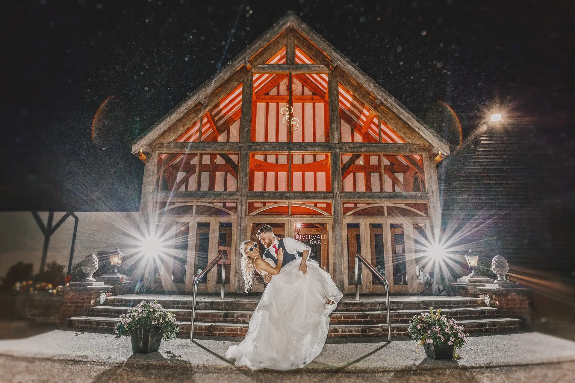 Couple having their wedding photos taken outside the venue at night